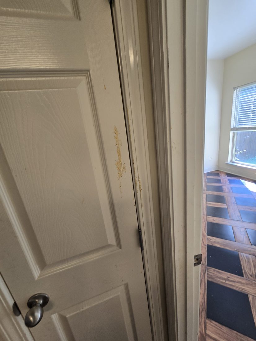 Interior door and frame with dried splatter before Kidoti Clean rehab cleaning, Birmingham AL