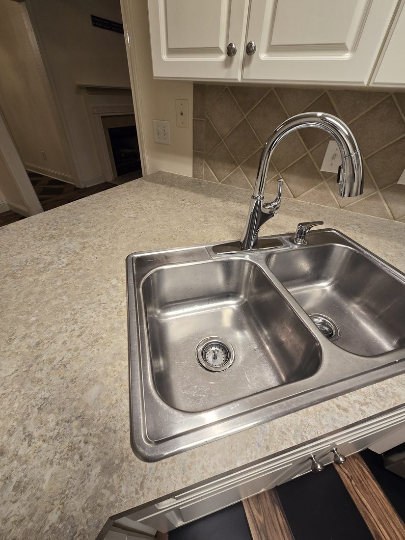Clean stainless kitchen sink and cleared counter after Kidoti Clean rehab cleaning, Birmingham AL