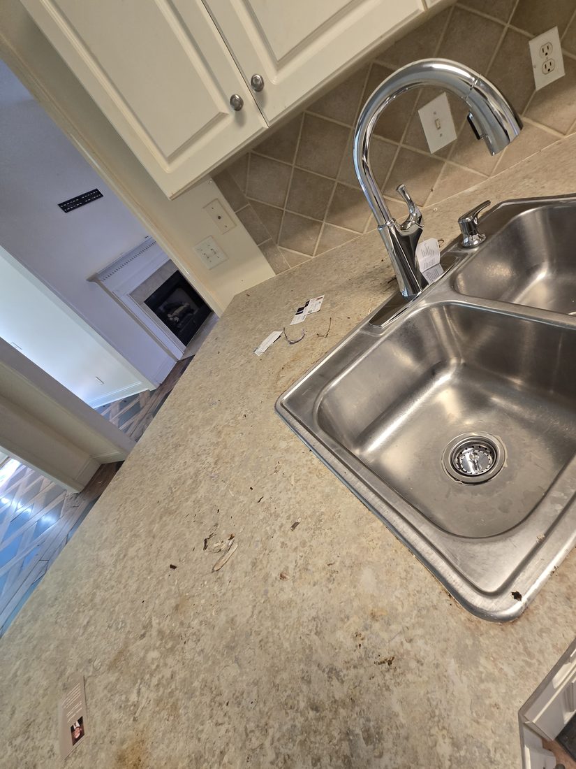 Kitchen sink and counter with debris before Kidoti Clean rehab cleaning, Birmingham AL