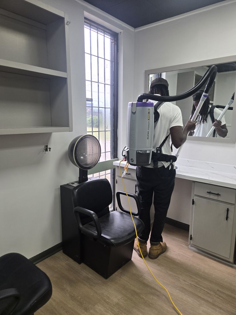 Kidoti Clean crew member removing construction dust in a salon styling suite, Birmingham AL