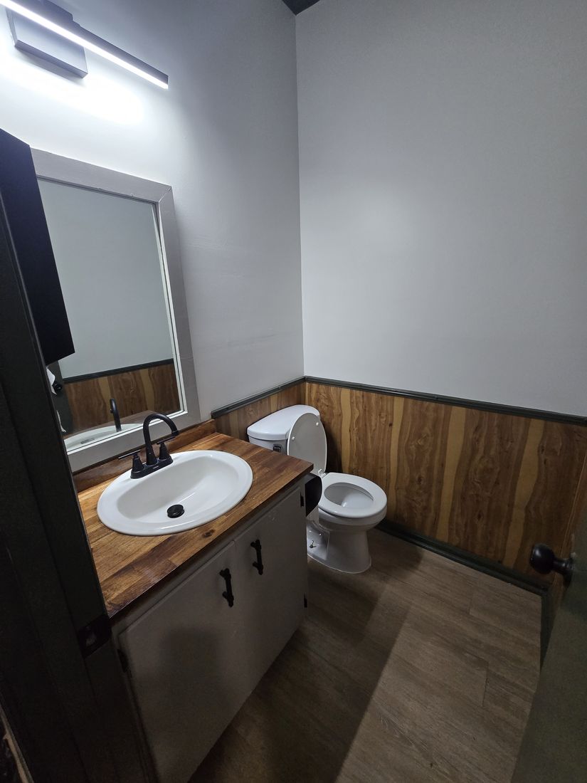 Clean salon restroom with vanity, sink and toilet after Kidoti Clean post-construction cleaning, Birmingham AL
