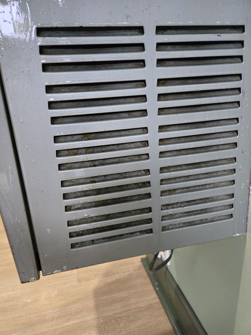 Gray vent cover with dust packed in the slots before Kidoti Clean post-construction cleaning, Birmingham AL