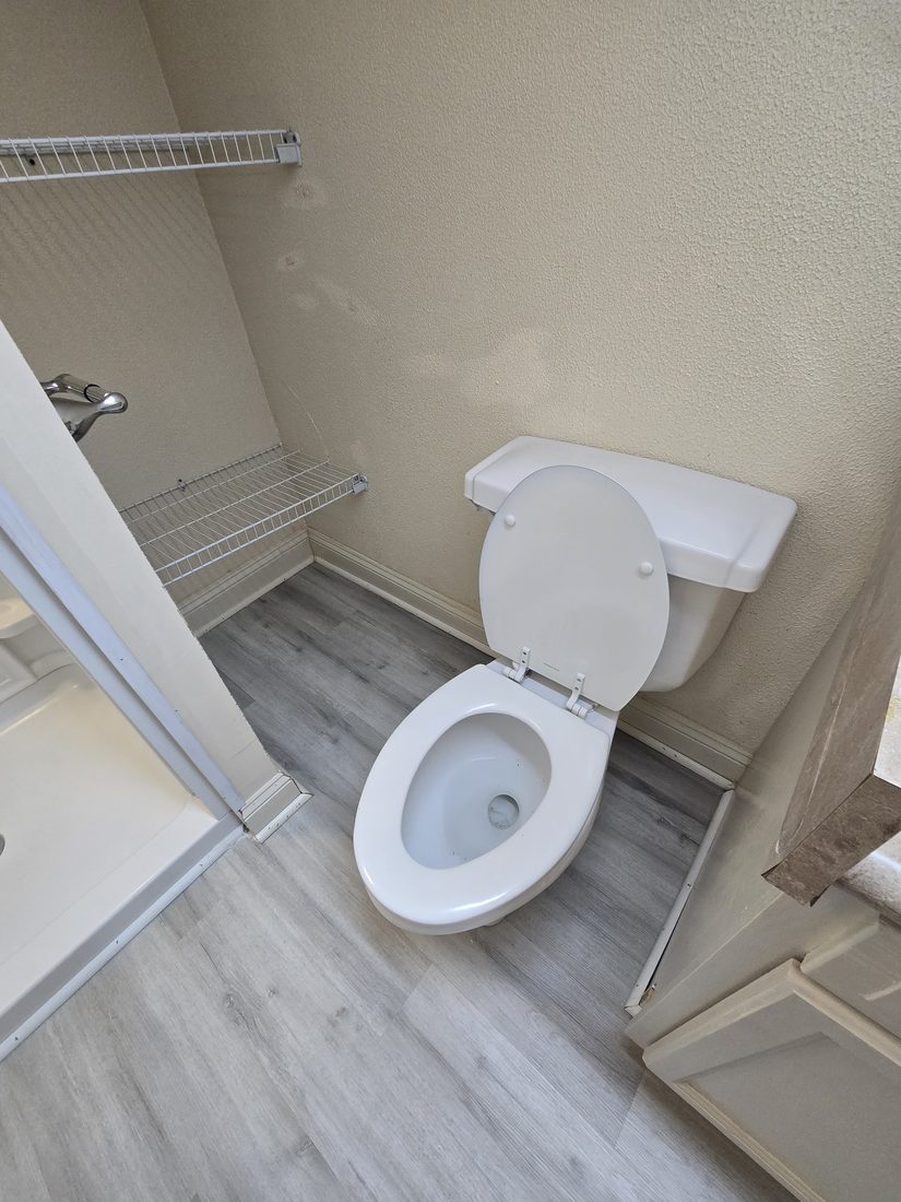 Clean toilet and cleared floor after Kidoti Clean rehab cleaning, Birmingham AL