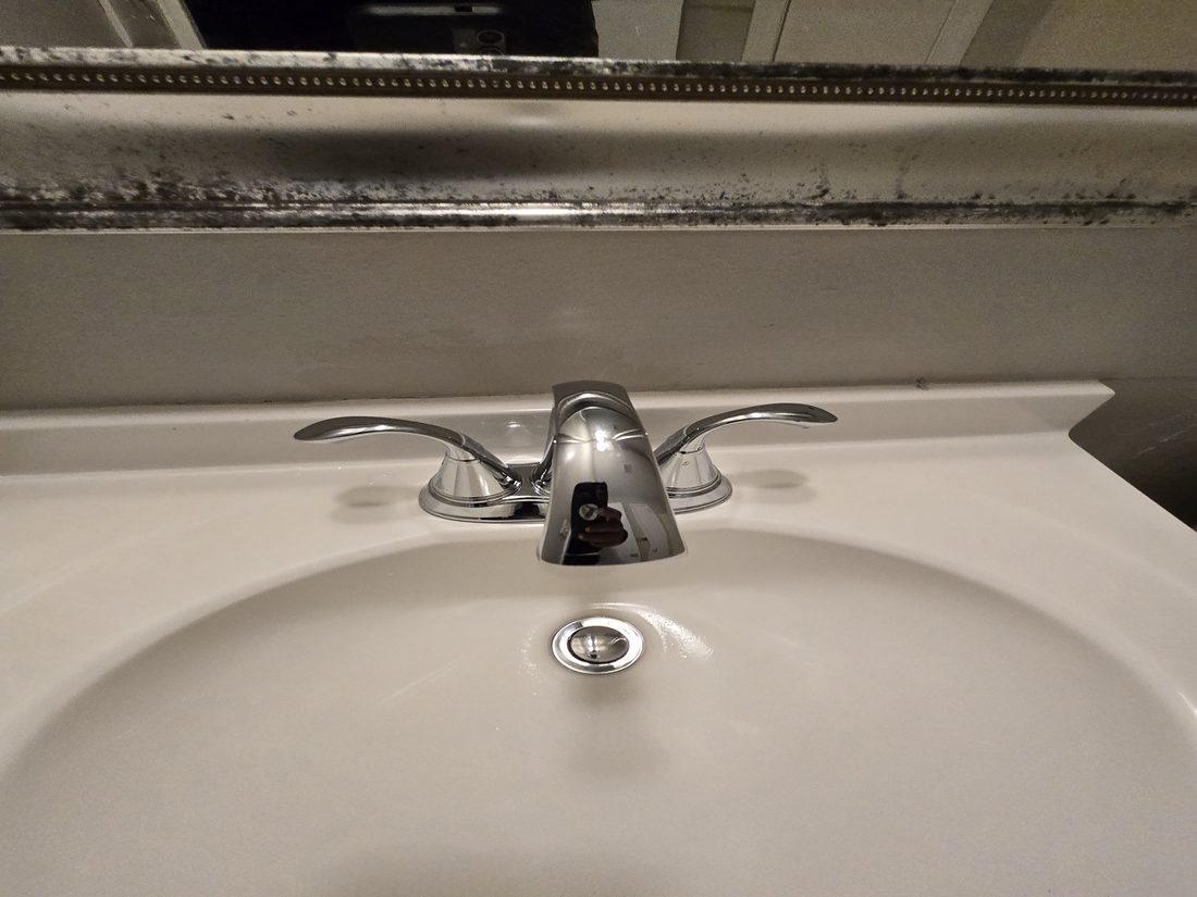 Bathroom vanity and mirror before Kidoti Clean turnover, Birmingham AL